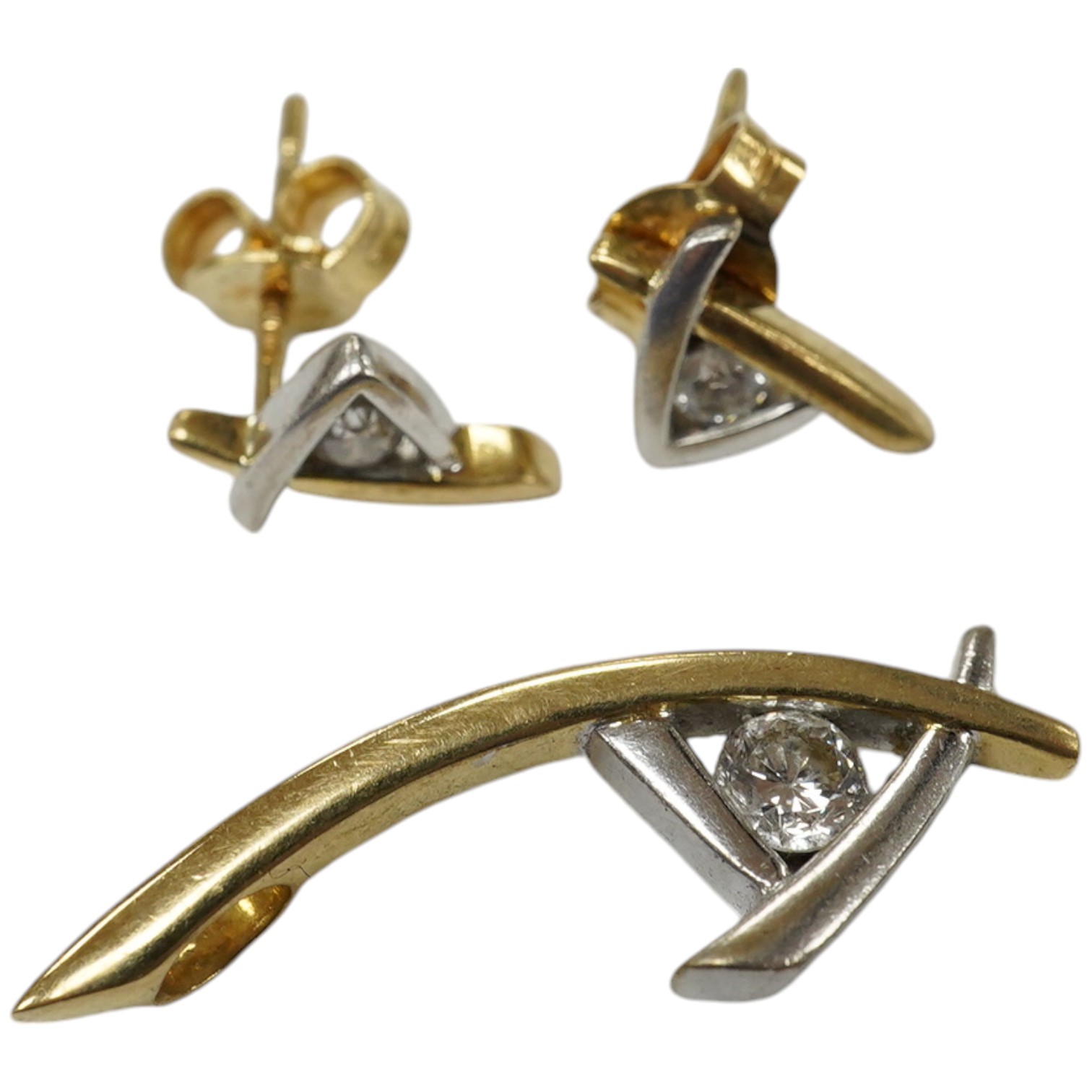 A modern two colour 18ct gold and single stone diamond set pendant, 25mm and a pair of matching ear studs, gross weight 4.5 grams. Condition - fair to good